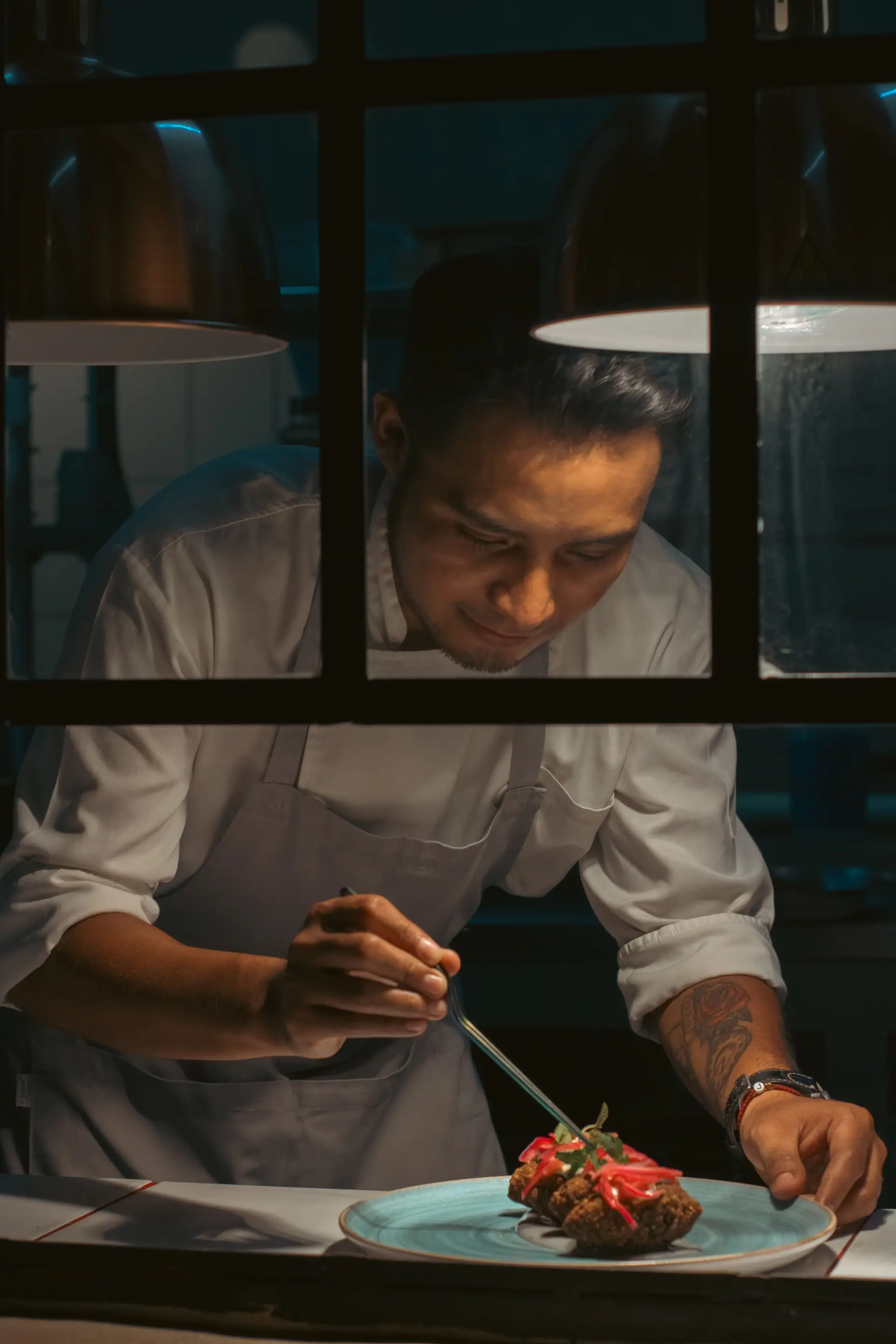 Chef meticulously plating a gourmet dish