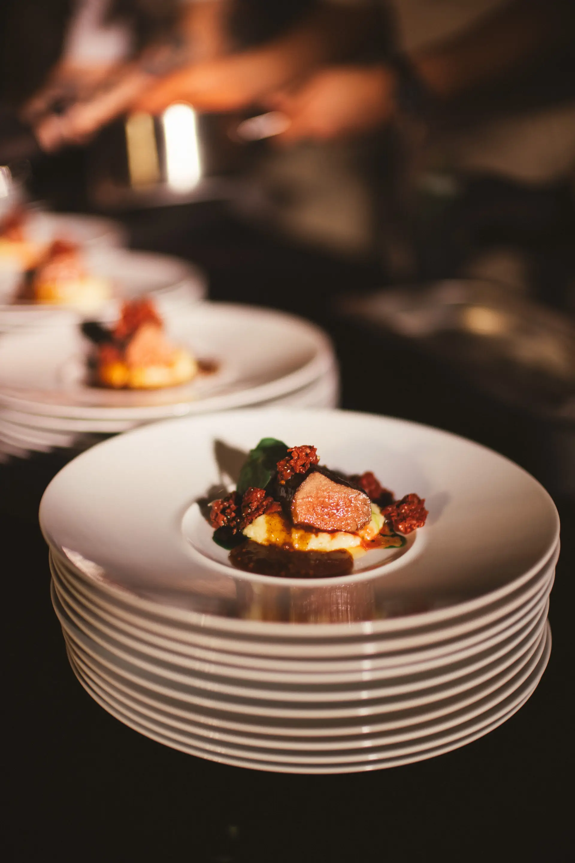 Gourmet fine dining presentation on dark porcelain
